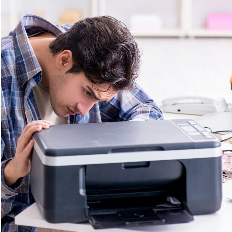 man fixing printer