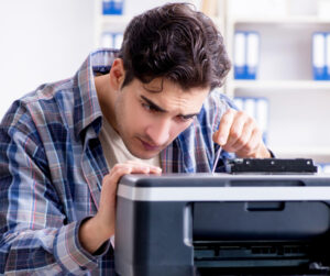 man fixing printer